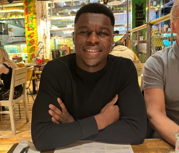 Leicester College student, Leon Tulloch smiling whilst sitting in a restaurant