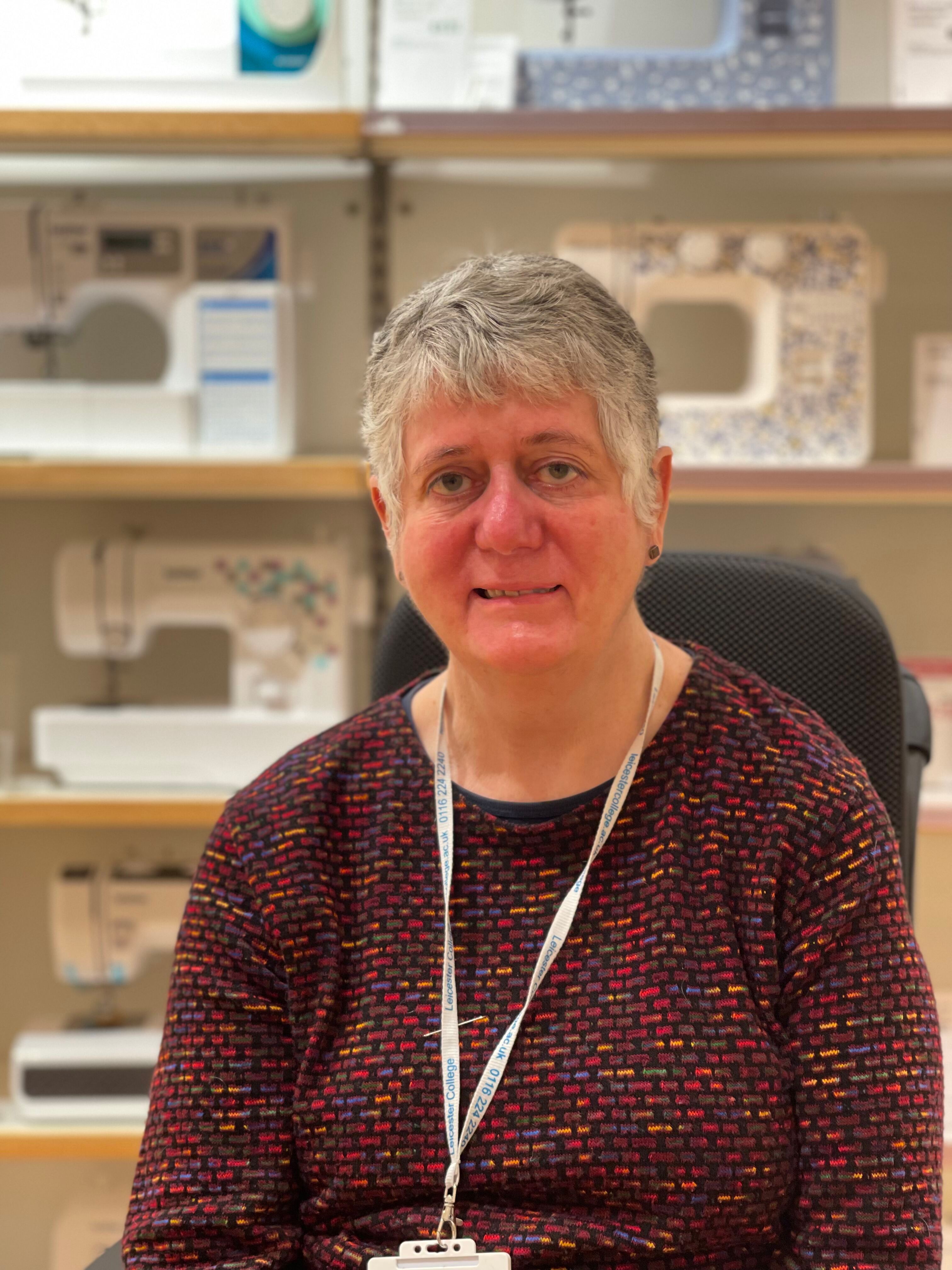 Sheila Hawkins sat in front of sewing machines