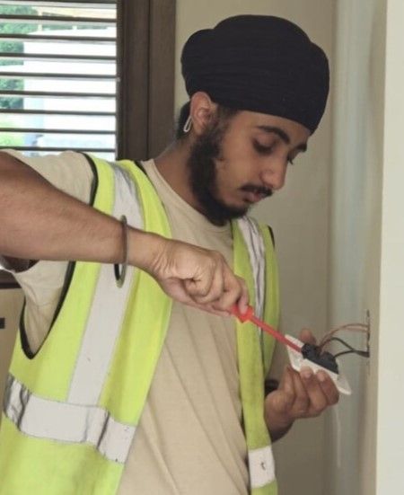 Leicester College Electrical Installation T level student, Tanvir Singh, fixing a light switch