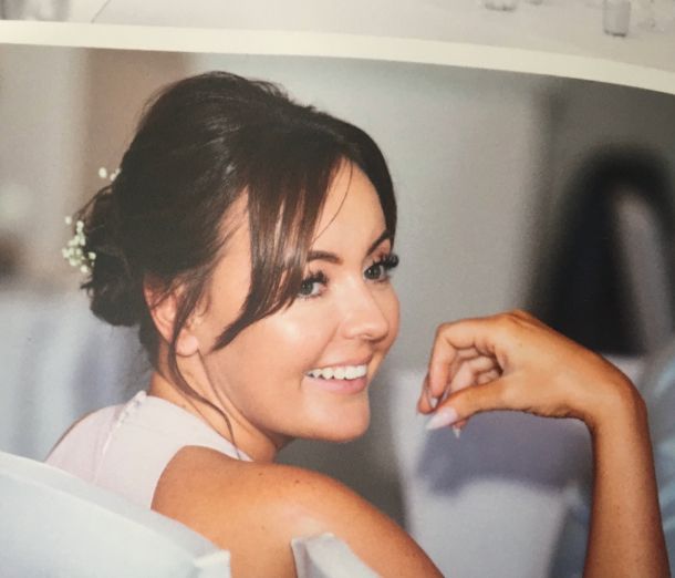 Leicester College student Laura Coleman, wearing a white dress and smiling