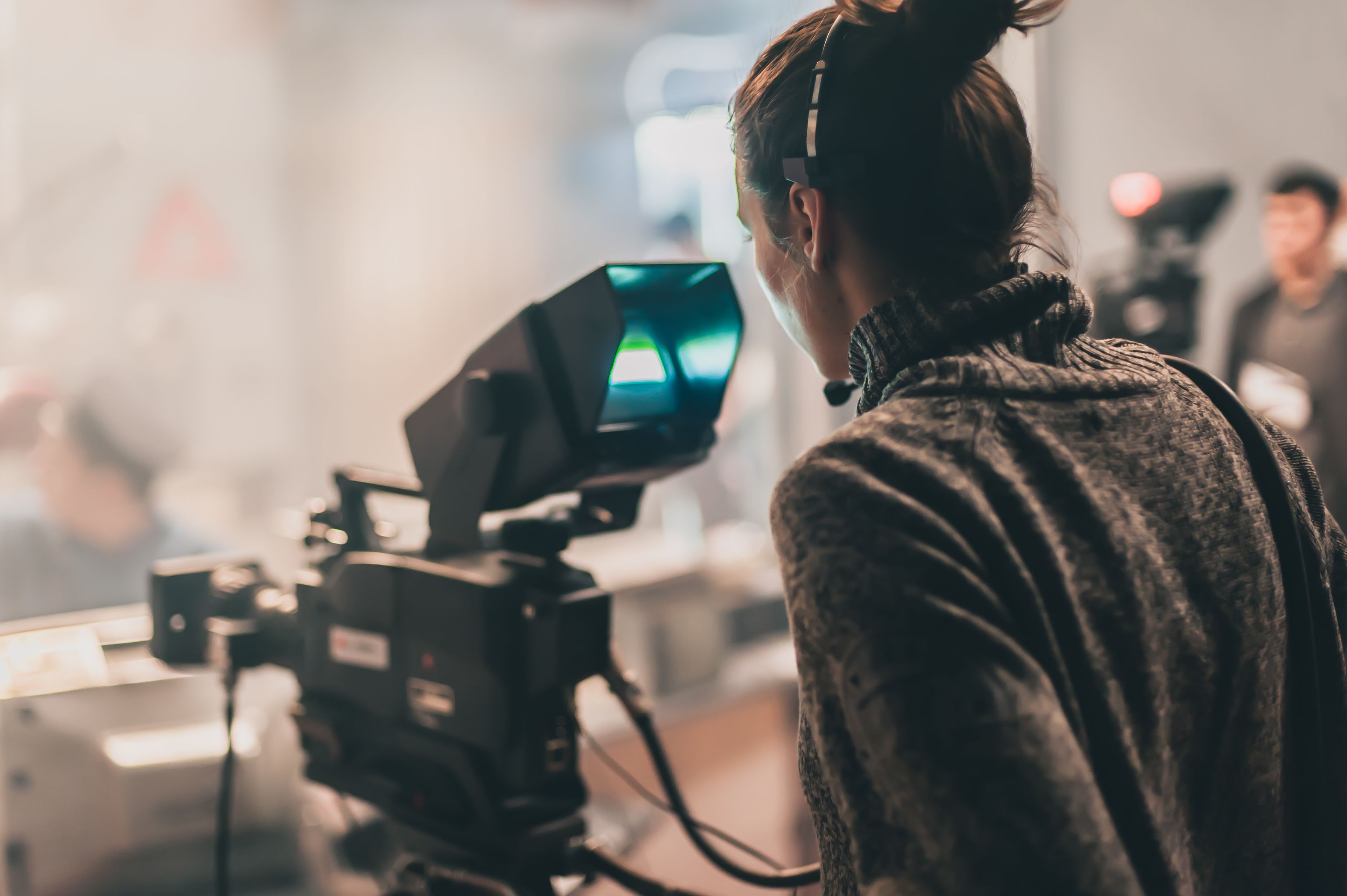 white woman looking at television camera