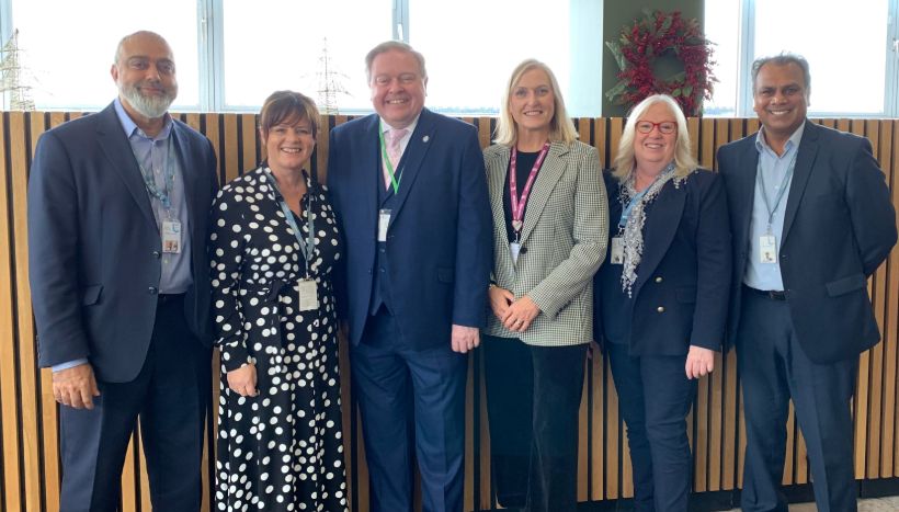 Martin Traynor standing with Leicester College staff