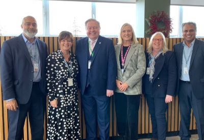 Martin Traynor standing with Leicester College staff