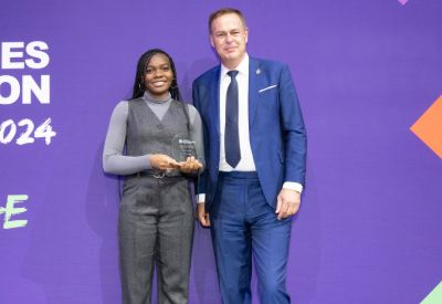 Leicester College student Shazin McCook holding her award for National Student of the Year stood next to Peter Jones CBE