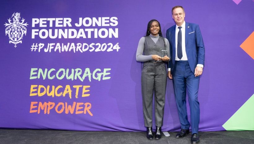 Leicester College student Shazin McCook holding her award for National Student of the Year stood next to Peter Jones CBE