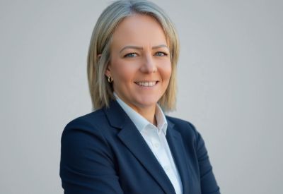 Amanda Scott, new Director of Human Resources, smiling while facing the camera, wearing a blue suit jacket