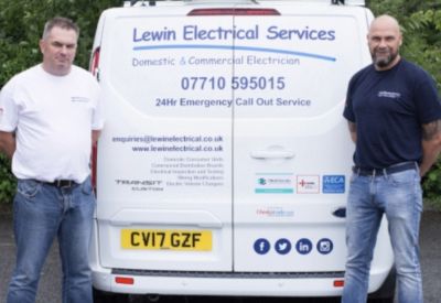 Lewin Electrical Services director Daniel Lewin (left) standing with colleague at the rear of a company van