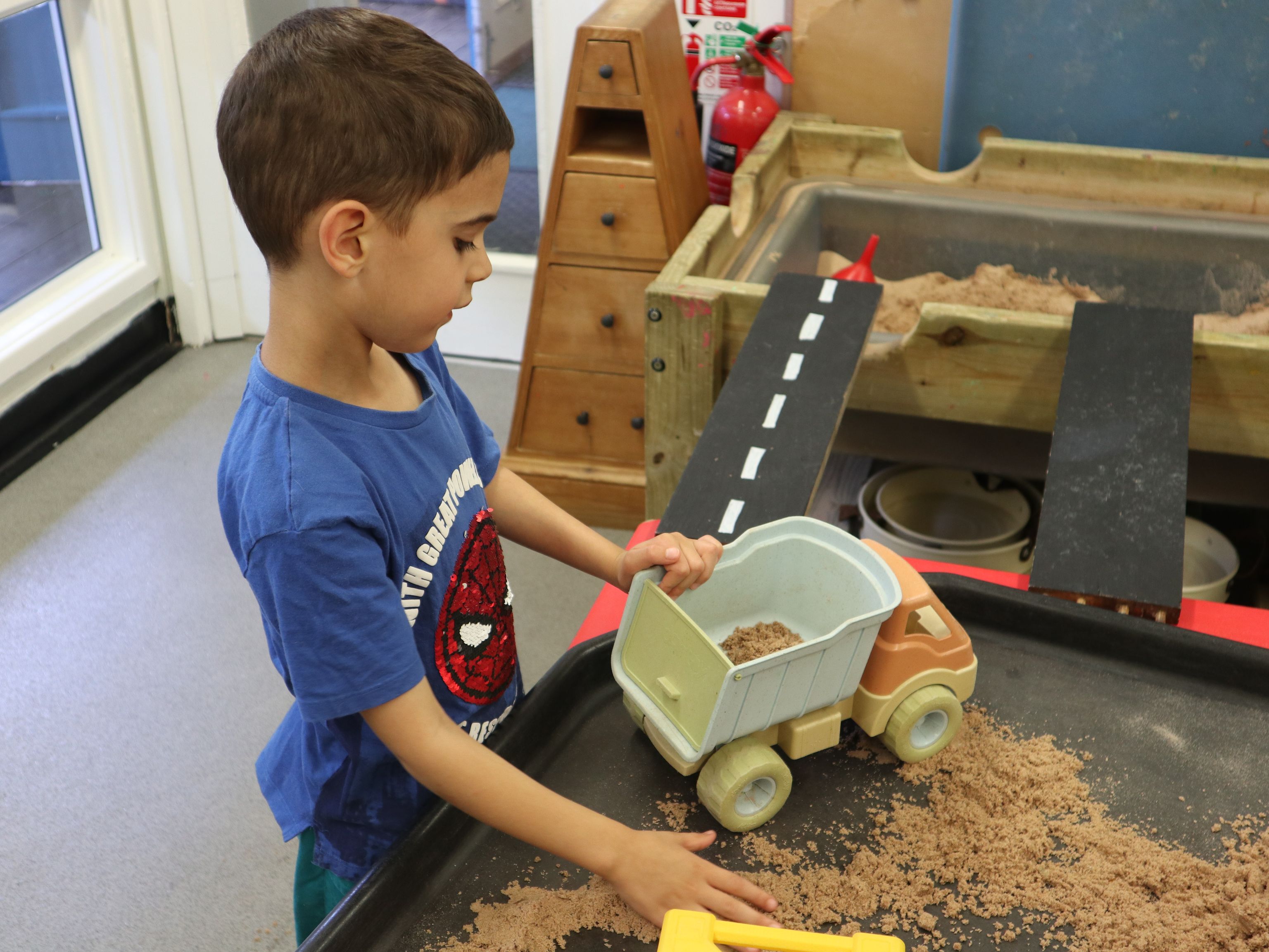 boy playing with sand