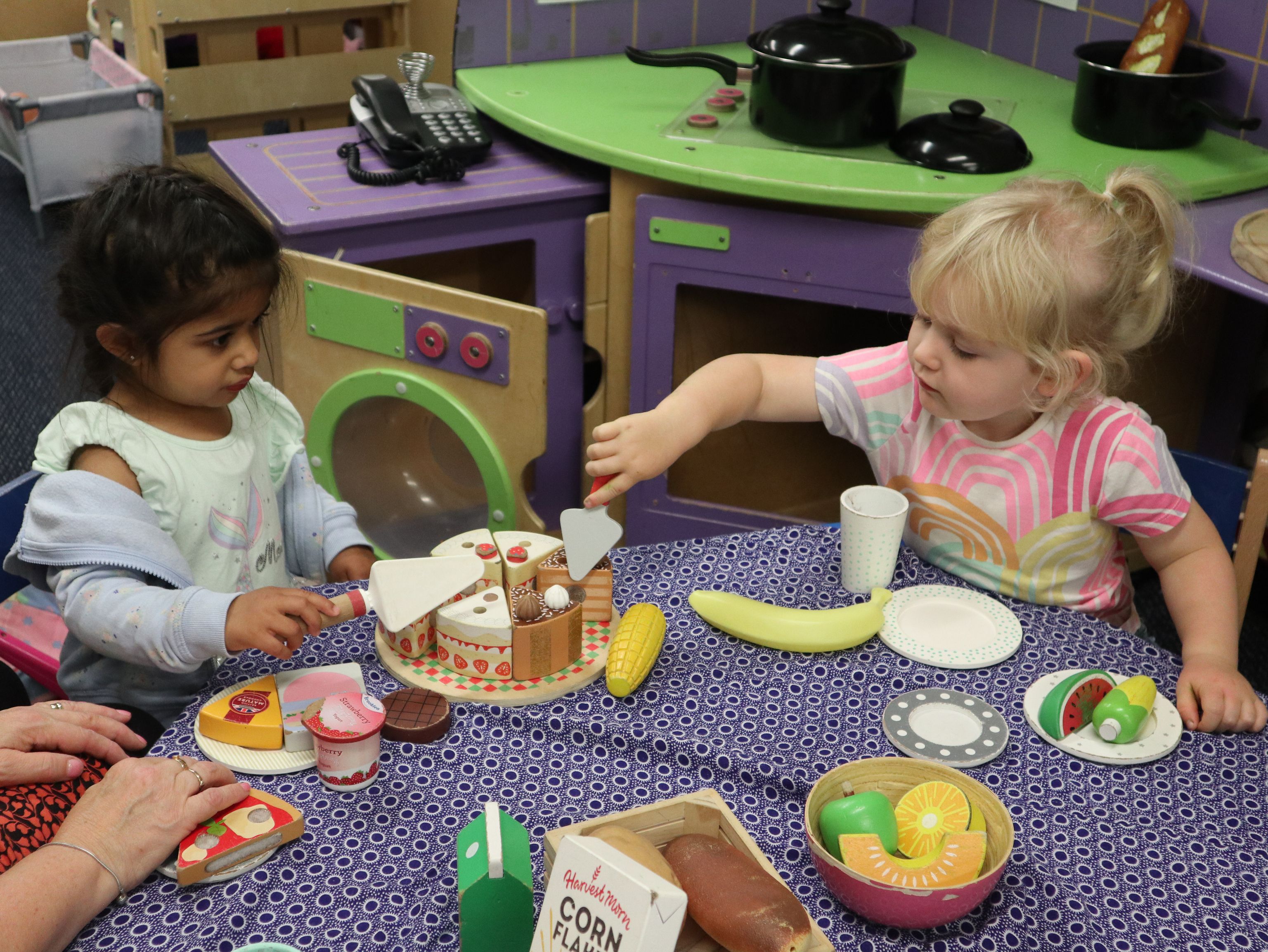 children playing with toys around the table