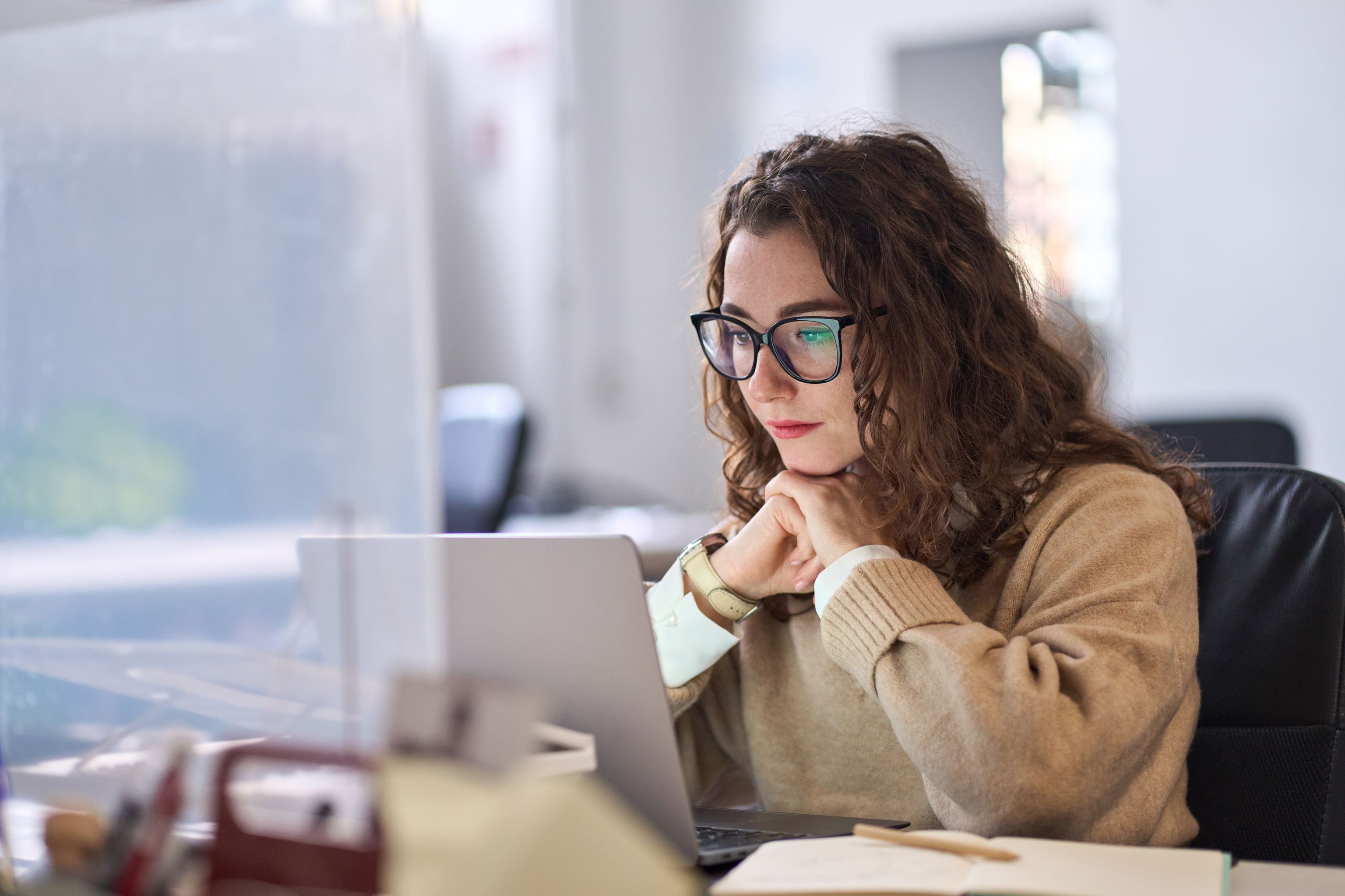 Young white woman working at a laptop