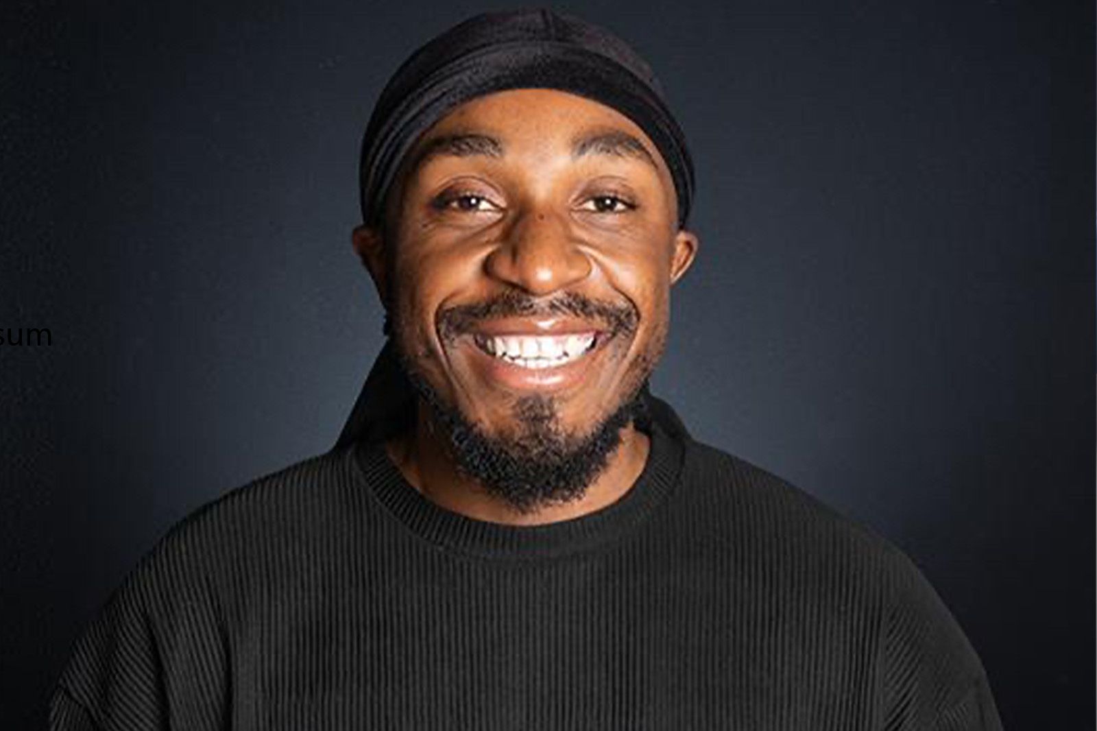 picture of Pak a black male with a beard smiling at camera