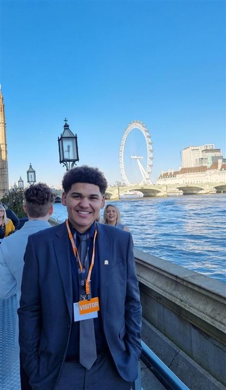 Picture of Brandon Power - SU president with London Eye behind him.