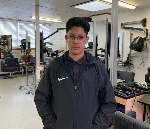 Leicester College Barbering student Luuqman Sattar standing in the training salon on campus