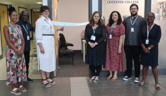 Photo of staff outside the careers hub at Abbey Park Campus, with one white women cutting the ribbon